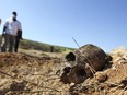 A scull is seen next to a mass grave used for cholera deaths is seen outside of Port au Prince, Haiti Friday Nov 26, 2010.