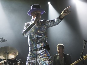 Gord Downie, center, and Gord Sinclair of The Tragically Hip perform on Wednesday, Aug. 10, 2016, in Toronto.