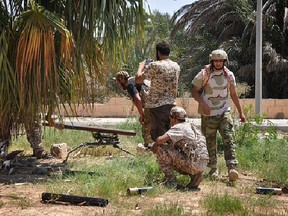 Members of forces loyal to Libya's unity government take part in the military operations against the Islamic State group in Dollar neighborhood in the center of Sirte, situated 450 kilometres east of Tripoli.