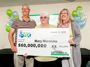Fred Wernicke, left, Mary Wernicke, center, and Julie Welk, right, hold a novelty lottery cheque during a cheque presentation at DoubleTree hotel in Regina, Saskatchewan on Thursday August 25, 2016. Mary Wernicke won $60 million on the August 12 LOTTO MAX draw.