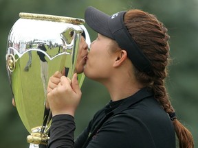 Ariya Jutanugarn, from Thailand, kisses the trophy after winning the LPGA Canadian Open in Priddis, Alta. on Aug. 28.