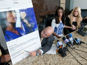 Attorney Richard Wolfe points to an Instagram post of former Miss Florida USA Genesis Davila, centre, getting her makeup done. Pageant officials stripped Davila of the crown saying she violated contest rules when she had her makeup professionally done, but Davila claims the photo was taken more than a week before the pageant.