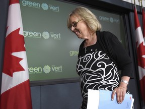 Green Party Leader Elizabeth May leaves the stage after announcing her plan to stay on as leader of the Green party