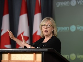 Green Party Leader Elizabeth May gestures as she makes an announcement at the National Press Theatre, in Ottawa on Monday.