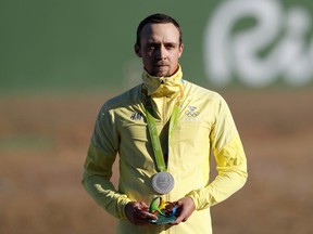 Silver medallist Marcus Svensson, of Sweden, during the victory ceremony for the men's skeet final at the Olympic Shooting Center in Rio de Janeiro on Saturday. Athletes are given sculptures of the Rio Games logo in place of flowers during the medal ceremony.