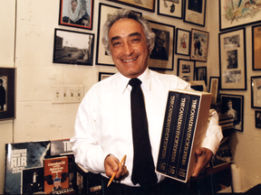 Mel Hurtig with a copy of the Canadian Encylopedia in 1985.