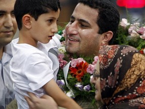 In this July 15, 2010 file photo, Shahram Amiri, an Iranian nuclear scientist greets his son Amir Hossein as he arrives to the Imam Khomeini airport after returning from the United States, outside Tehran, Iran. Amiri, who was caught up in a real-life U.S. spy mystery and later returned to his homeland and disappeared, has reportedly been executed under similarly mysterious circumstances.
