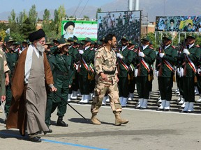 Iranian Supreme Leader Ayatollah Ali Khamenei, left, reviews Revolutionary Guard cadets during a graduation ceremony in Tehran in 2015.