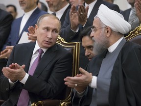 Russian President Vladimir Putin and Iran's President Hassan Rouhani attend a signing ceremony in Tehran.