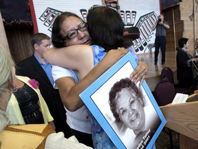 Bridget Tolley, whose mother Gladys was killed in 2001, is embraced after the announcement of the inquiry into Murdered and Missing Indigenous Women at the Museum of History in Gatineau, Quebec on Wednesday, Aug. 3, 2016.