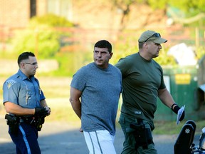 Ralph A. Santaniello, 49, of Longmeadow, is led to a cruiser at the Massachusetts State Police barracks in Springfield early Thursday morning, Aug. 4, 2016.