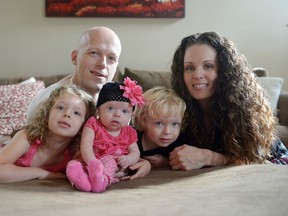 In this Sept. 1, 2014, photo, Willow Short, 4-month-old, center, along with her parents Megan and Mark and sister Liana, 6, and brother Mark, 3, poses for a photo in Sinking Spring, Pennsylvania.