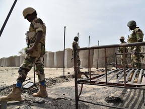 Niger's soldiers stand at Bosso military camp on June 17, 2016 following attacks by Boko Haram fighters in the region.