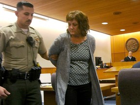 In this March 30, 2016, file photo, Jane Laut is led out of the courtroom in custody after being found guilty in Ventura, California. Laut was sentenced Tuesday, Aug, 23, 2016, to two consecutive terms of 25 years to life, one for first-degree murder and the other for using a gun in the killing.