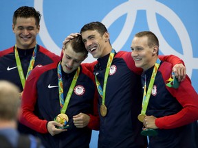 Gold medalists Nathan Adrian, Ryan Held, Michael Phelps and Caeleb Dressell of the United States pose on the podium during the medal ceremony for the Final of the Men's 4 x 100m Freestyle Relay on Day 2 of the Rio 2016 Olympic Games. (Julian Finney/Getty Images)