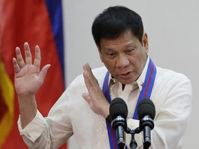 Philippine President Rodrigo Duterte gestures during the "Assumption of Command" of new Police Chief, Director General Ronald Dela Rosa at Camp Crame, Philippine National Police headquarters, in suburban Quezon city, Philippines on July 1. Duterte publicly linked more than 150 judges, mayors, lawmakers, police and military personnel to illegal drugs Sunday, Aug. 7, 2016.