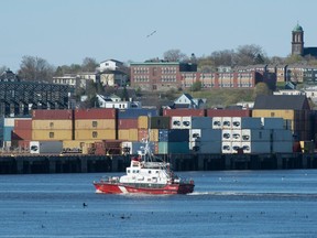 A coast guard ship patrols the Saint John River in Saint John, New Brunswick, Wednesday May 19, 2016.