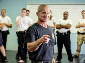 Michael Schlosser, director of the Police Training Institute at the University of Illinois, offers new recruits training on interactions with minority communities.