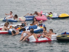 Floaters travel down the St. Clair River during Float Down at Lighthouse Beach in Port Huron, Mich., Sunday, Aug. 21, 2016. Thousands of people gathered for the event and floated down the St. Clair River.