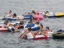 Floaters travel down the St. Clair River during Float Down at Lighthouse Beach in Port Huron, Mich., Sunday, Aug. 21, 2016. Thousands of people gathered for the event and floated down the St. Clair River. 