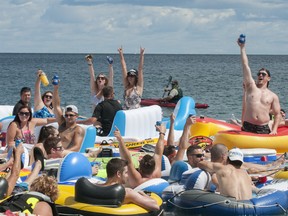 People celebrate as they start the Float Down at Lighthouse Beach in Port Huron, Mich., Sunday, Aug. 21, 2016.