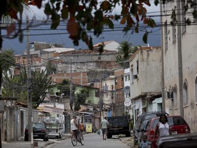 Residents move about the slum "Cidade de Deus," or City of God, in Rio de Janeiro, Brazil, in this July 22, 2016 photo.