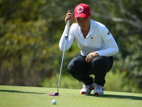 Canada's Brooke Henderson lines up her putt during the first round of the women's golf event at the 2016 Olympics in Rio de Janeiro on Wednesday, Aug. 17, 2016.