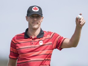 Canada's Graham DeLaet waves to the crowd on the 18th hole after finishing his round of 66, which has him in a second-place day after the first round.
