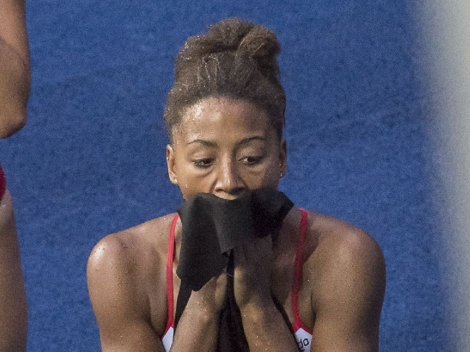 Pamela Ware, left, and Jennifer Abel, of Canada, share a laugh