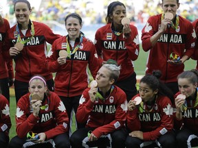 The Canadian women pose with their bronze medals following their 2-1 win over Brazil at the Corinthians Arena in Sao Paulo on Friday Aug. 19, 2016.