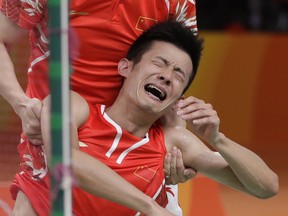 China's Chen Long celebrates after winning his men's badminton singles final match against Malaysia's Lee Chong Wei at the 2016 Summer Olympics in Rio de Janeiro, Brazil, Saturday, Aug. 20, 2016.