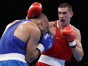 Russia’s Evgeniy Tishchenko, right, fights Brazil’s Juan Nogueira during a men’s heavyweight preliminary boxing match at the 2016 Summer Olympics in Rio de Janeiro, Brazil, on Monday.