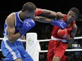 Namibia's Junias Jonas, right, fights France's Hassan Amzile during a men's light welterweight 64-kg preliminary boxing match at the 2016 Summer Olympics in Rio de Janeiro, Brazil, Thursday, Aug. 11, 2016.