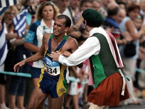 Defrocked Irish priest Neil Horan, right, grabs Vanderlei de Lima of Brazil and knocks him into the crowd during the men's marathon at the 2004 Olympic Games in Athens, Sunday, Aug 29, 2004.
