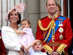 Catherine, Duchess of Cambridge, Princess Charlotte, Prince George and Prince William, Duke of Cambridge watch a fly past during the Trooping the Colour, this year marking the Queen's 90th birthday at The Mall on June 11, 2016 in London, England.