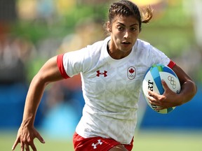 Bianca Farella of Canada runs with the ball to score a try during the Women's Pool C rugby match between Canada and Japan on Day 1 of the Olympics.