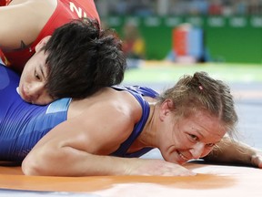 China's Xu Rui (red) competes with Russia's Inna Trazhukova (blue) during the women's wrestling 63kg quarter-finals
