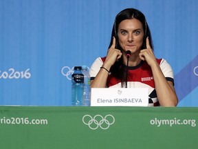 Yelena Isinbayeva, Russia's pole vault world record holder, listens to a translation of a question during a news conference at the 2016 Summer Olympics in Rio de Janeiro on Friday, Aug. 19, 2016. Isinbayeva announced her retirement from competition during the conference.