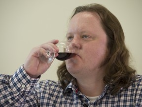 National Post columnist Chris Selley tastes red wine while being coached on how to taste wines by certified specialist of wine Paul Sturgess at the Independent Wine Education Guild in Toronto, Ontario on Monday, July 25, 2016.