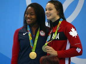 Simone Manuel (left) of the United States and Penny Oleksiak (right) of Canada tied for gold in the women's 100m freestyle final on Aug. 11.