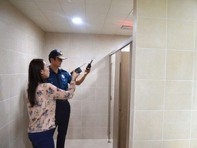 Police officers investigate the facilities at the national training center in Jincheon, South Korea.