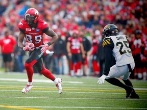 Calgary receiver DaVaris Daniels avoids a tackle by Hamilton's Emanuel Davis on Aug. 28.