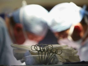 Surgeons at The Queen Elizabeth Hospital Birmingham conduct an operation on June 14, 2006, Birmingham, England.
