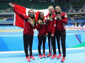 Brittany MacLean, Katerine Savard, Taylor Ruck and Penny Oleksiak get their pictures taken with their bronze medals from the women's 4x200-metre freestyle relay on Day 5 of the 2016 Olympic Games.