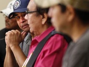 Norway House resident Leon Swanson weeps at a press conference in Winnipeg, Friday, August 26, 2016 where Manitoba's former aboriginal affairs minister Eric Robinson, centre, announced Swanson and David Tait Jr., right, were switched at birth in 1975 when their mothers gave birth at Norway House Indian Hospital.