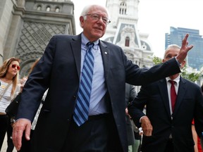 Sen. Bernie Sanders waves to a supporter in downtown Philadelphia, Thursday, July 28, 2016, during the final day of the Democratic National Convention.