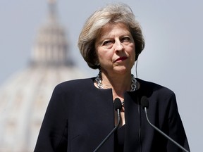 British Prime Minister Theresa May attends a press conference in Rome, with St. Peter's Basilica in the background, at the end of a meeting with Italian PM Matteo Renzi.