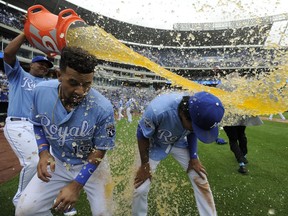 Cheslor Cuthbert, left, and Raul Mondesi of the Kansas City Royals are doused with Gatorade by Salvador Perez as they celebrate a 7-1 win against the Toronto Blue Jays at Kauffman Stadium on August 7, 2016.