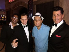 In this Aug. 12, 2016 photo courtesy of Russell Contreras, Rat Pack tribute performers Kyle Diamond, left, David De' Costa, second from left and Drew Anthony, right are shown with Associated Press reporter Russell Contreras, second from right, at the Tuscany Suites and Casino in Las Vegas.