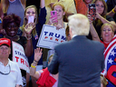 Donald Trump supporters cheer for him during a campaign event in Wilmington, North Carolina.
